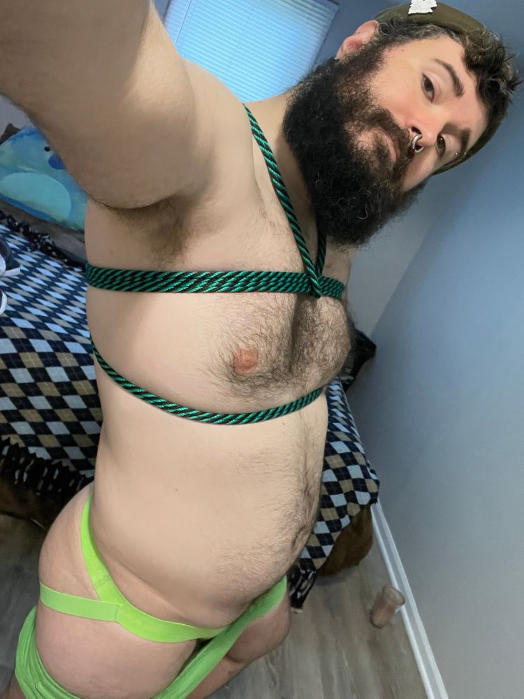 Standing in my bedroom with a black and green rope harness and lime green jock
