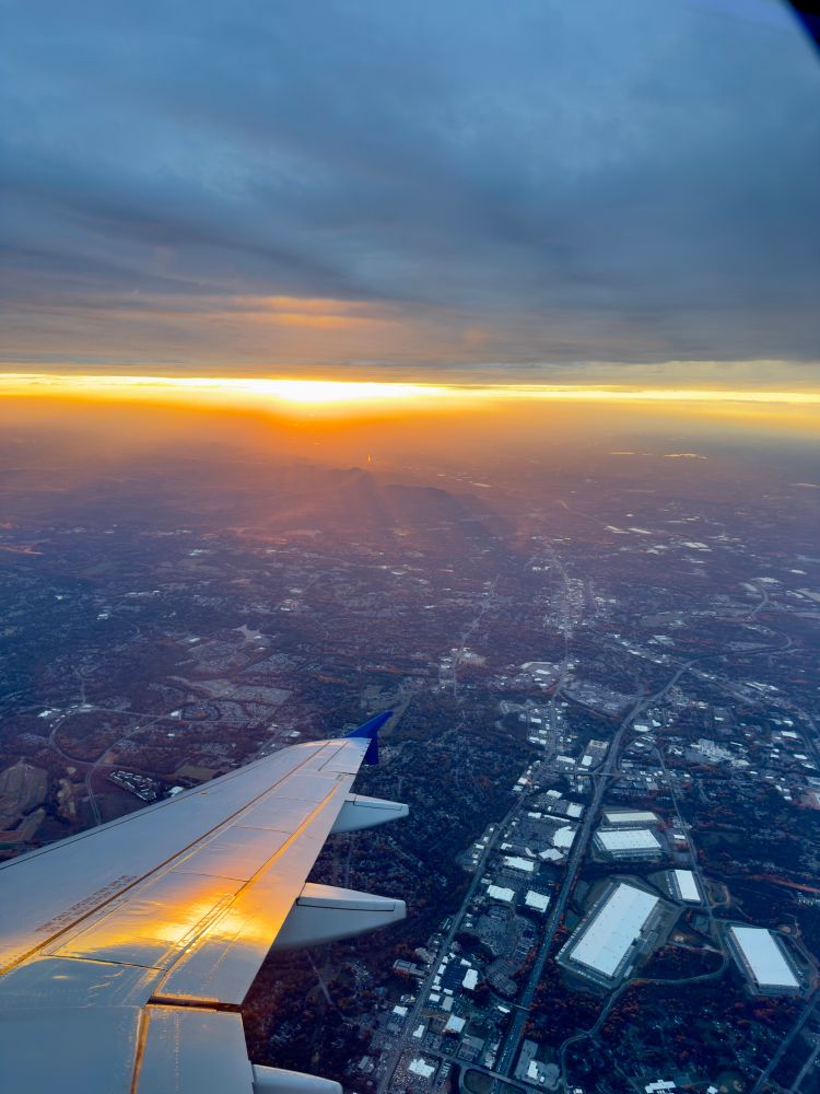 Another view of the the same sunset with a plane wing in the view. 