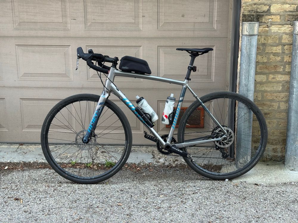 Photo of a miner bike propped up against a garage door. 