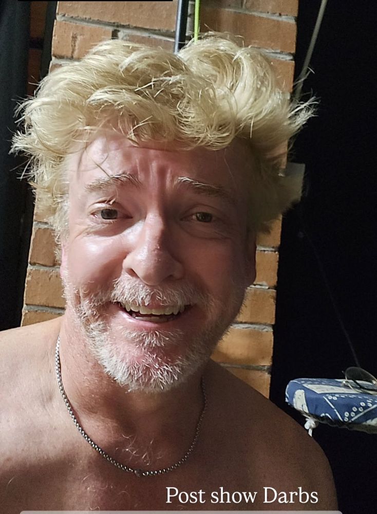 A topless Rhys selfie with his chain and messy hair that frankly should be illegal