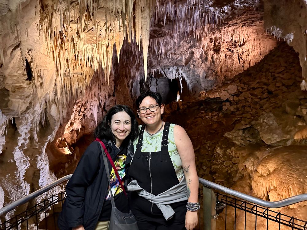 Two people in a cave with cool formations