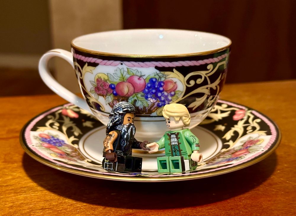 Lego Ed and Stede sitting on a teacup, the same design as the one used in the seven sugars scene