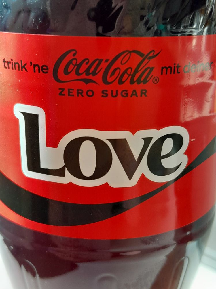 Close up of a coca cola zero bottle with a big label spelling love