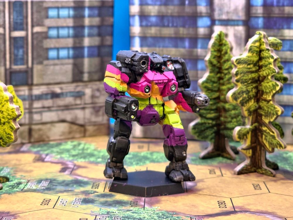 A BattleTech Regent, on hexmap amid papercraft terrain; the mini is painted in Queer Villain Pride colors