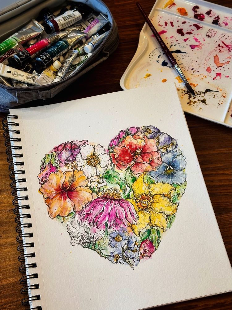 A progress photo of ‘Heart in Blooms,’ a watercolour painting of assorted flowers in the shape of a heart. 