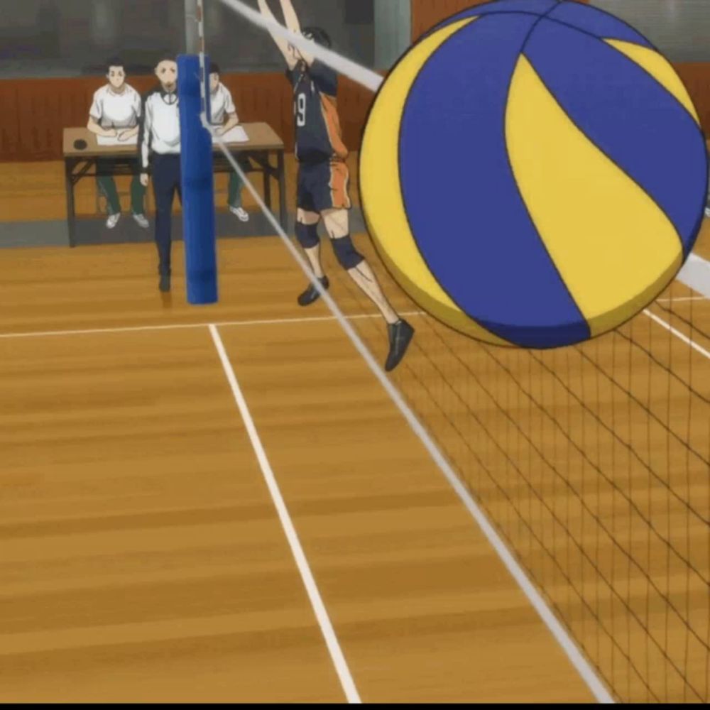 a volleyball player with the number 9 on his jersey is jumping to hit the ball