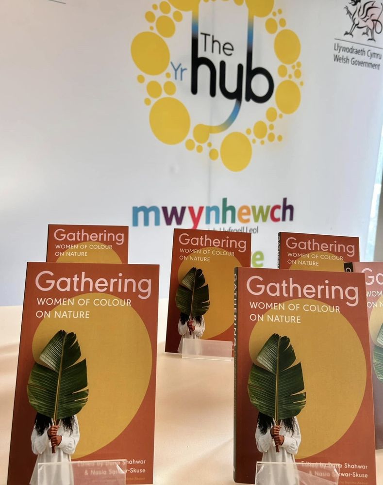 Copies of 'Gathering' on small book stands.