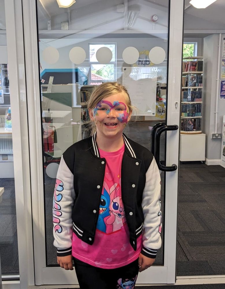 Smiling girl with facepaint, standing