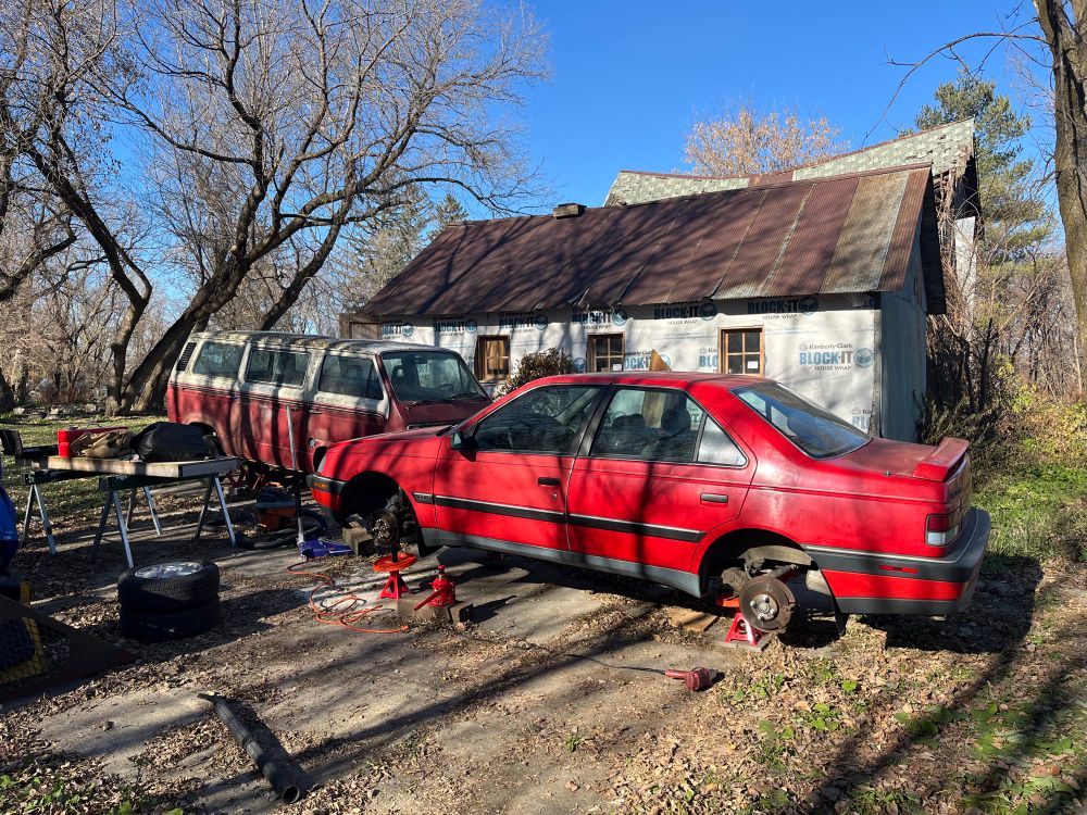 My Peugeot 405 Mi16 up on jack stands with its wheels removed 