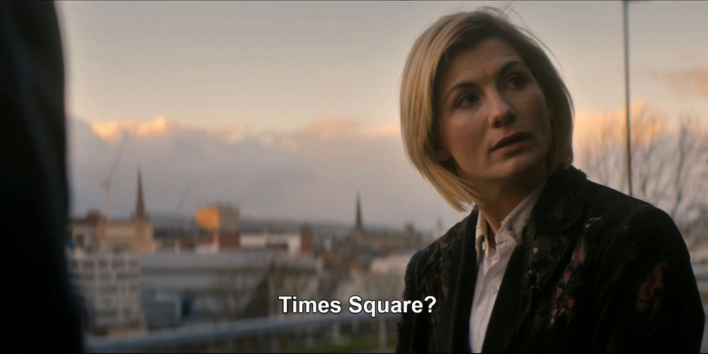 13, with a serious expression, says, "Times Square?"