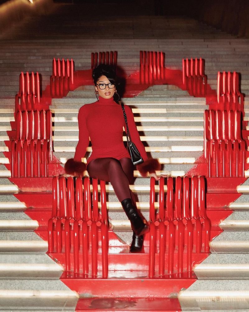 Megan thee stallion looking beautiful in red sitting on steps. 
