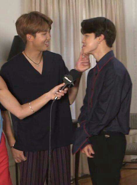 chocolate brown haired namjoon looking tan as fuck in a short sleeved shirt i cant even do anything besides look at him fucking shit and jimins got black hair and he's in a long sleeve and black slacks (his ass looks great too btw its a side view) anyways namjoon is reaching for his pouty bottom lip and if im not mistaken he was calling him cute or saying he was cute which is so fucking sick and twisted they kiss on the mouth 
