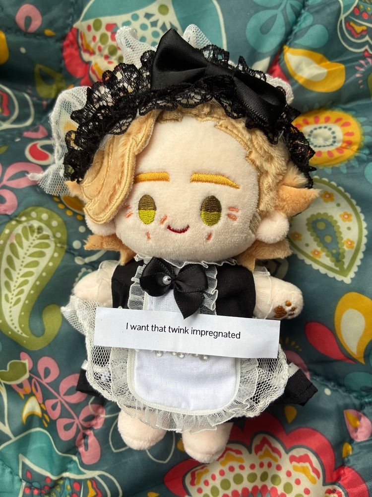 a rights 10cm stede doll dressed in a black maid’s outfit with a fortune cookie fortune that reads, “I want that twink impregnated”