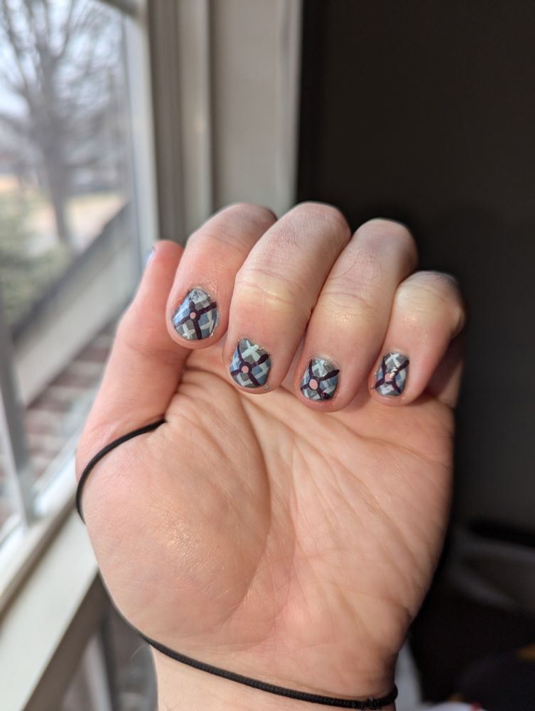 Photo of my hand displaying nail art composed of a fine plaid pattern.