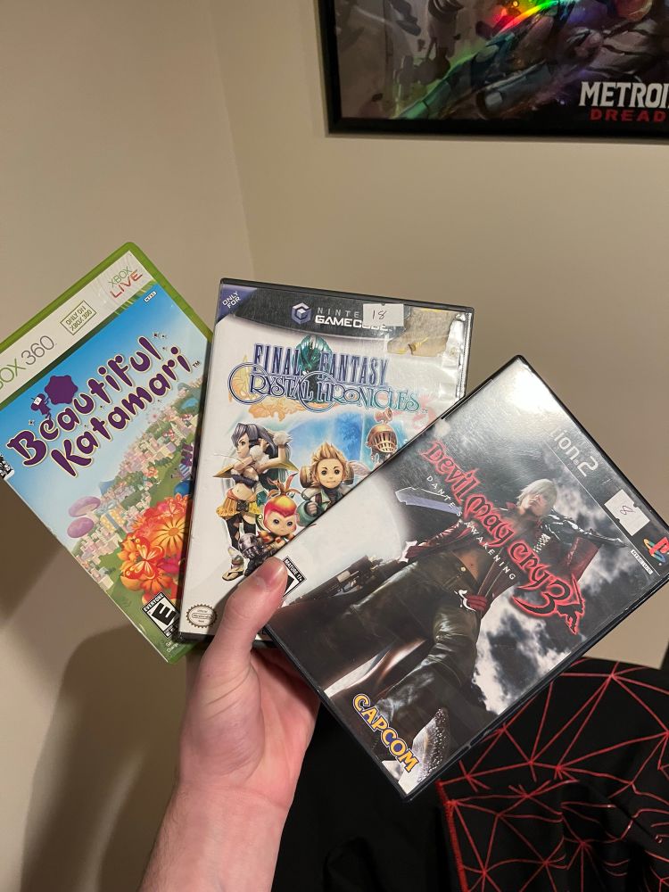 Mike holding 3 games: Beautiful Katamari, Final Fantasy Crystal Chronicles, and Devil May Cry 3
