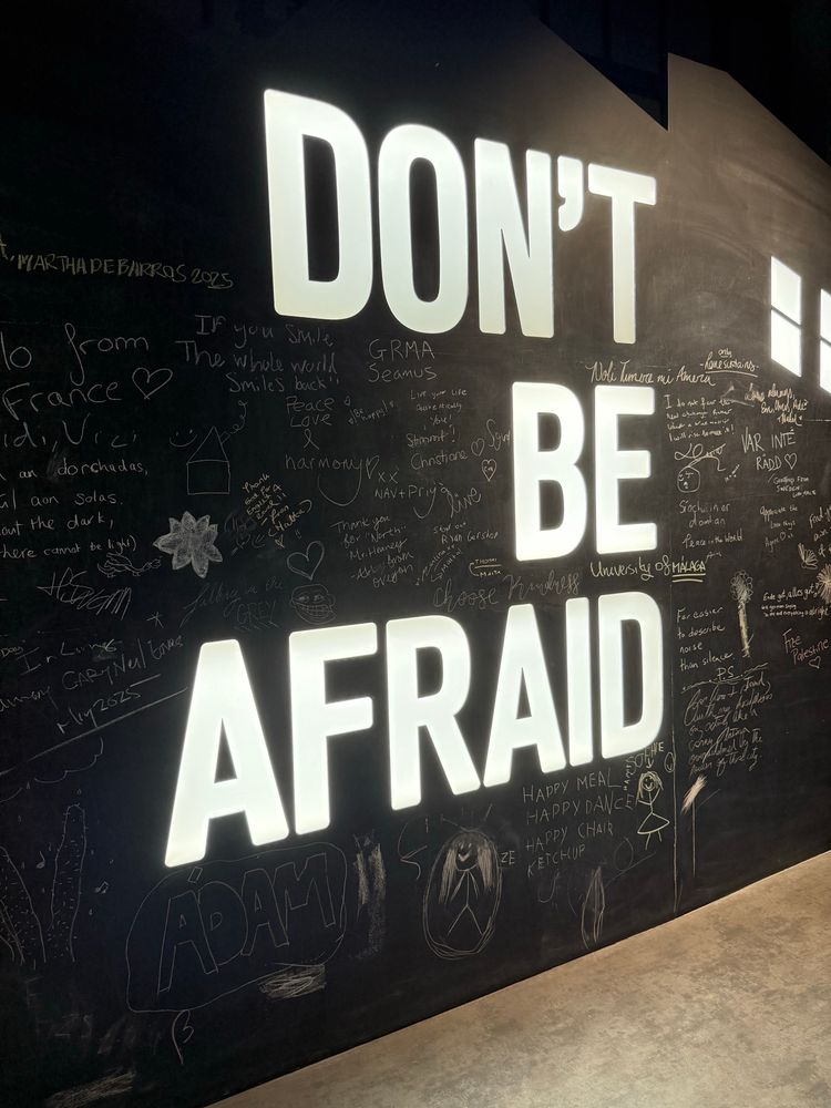 A photo of a chalkboard wall with the words don’t be afraid in pre painted caps, a word per line in huge font with room for chalkboard messages. There are lots of messages. Don’t be afraid being what seamus notably said to his wife on his deathbed 