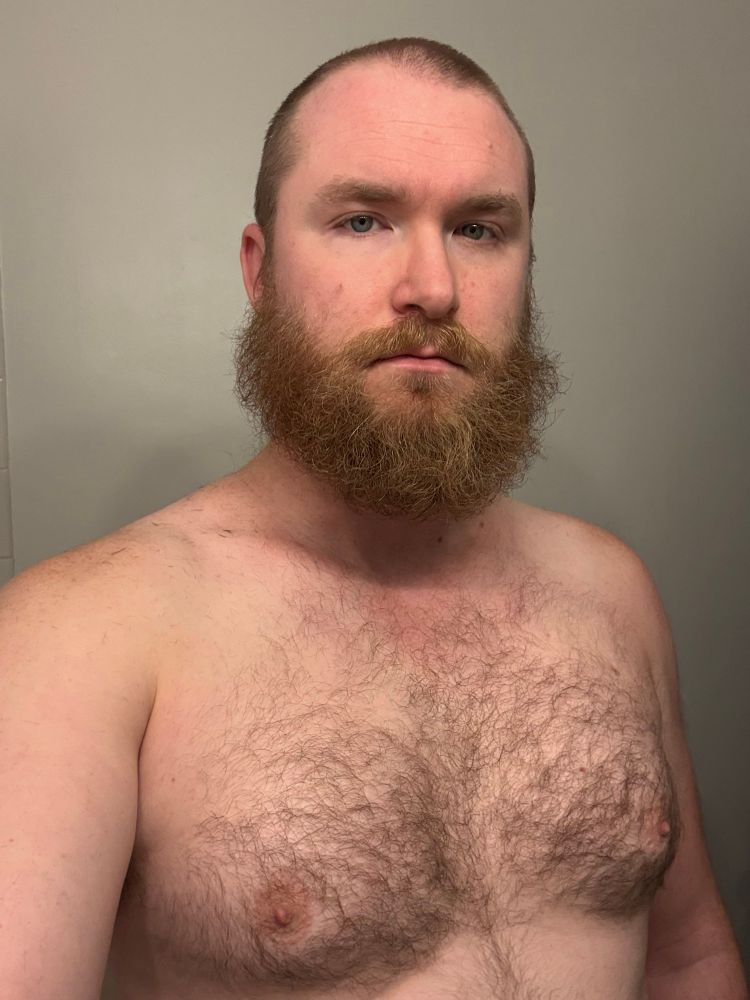 Bearded man with a hairy chest. 
