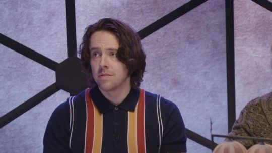 A screenshot of Brian Murphy, or Murph, from an episode of Cloudward, Ho! He's looking to the left with a sweet, smitten sort of expression, a whisper of a smile tugging at one side of his lips.