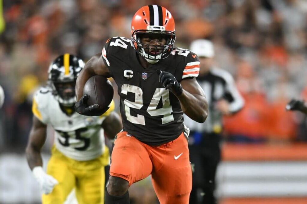 Cleveland Browns’ Nick Chubb wearing brown jersey and orange pants