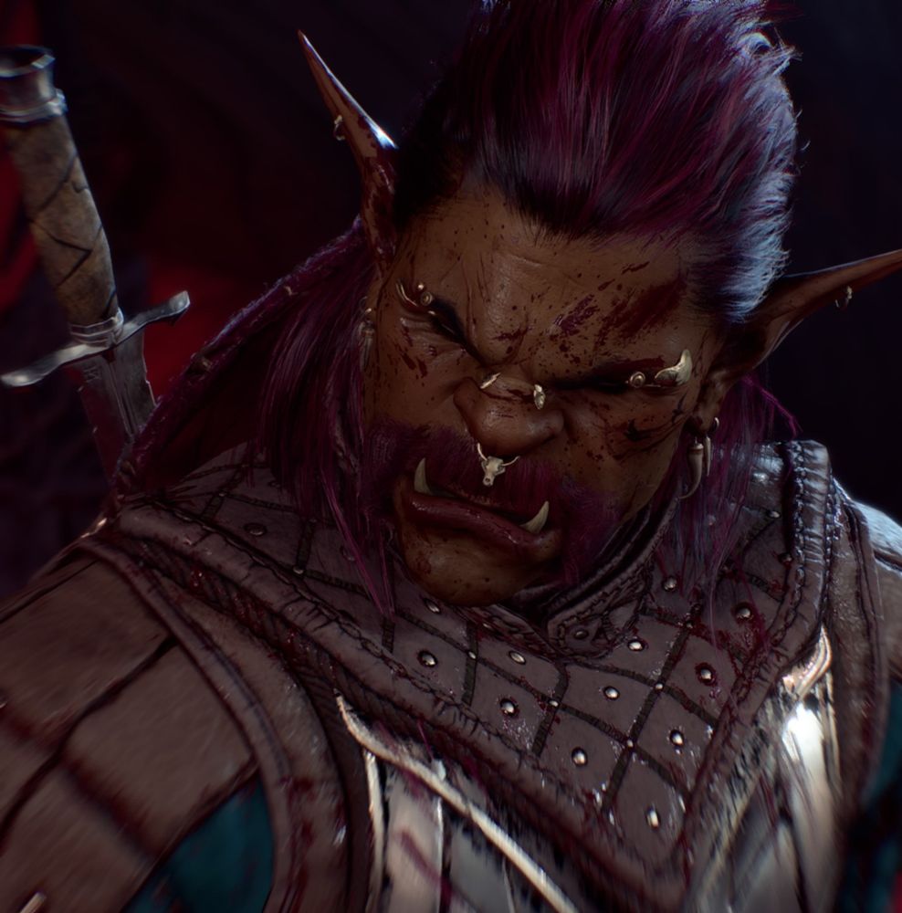 A dimly lit photo of a half-orc with red hair.