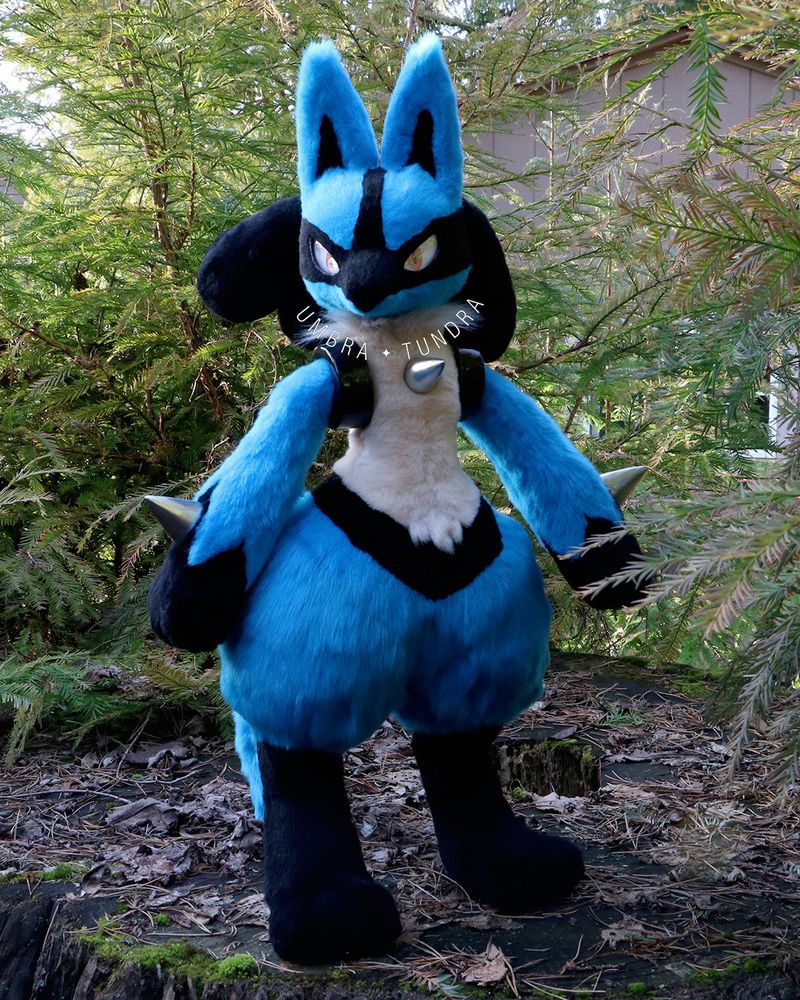Lucario art doll, it is standing up straight and looking at the camera