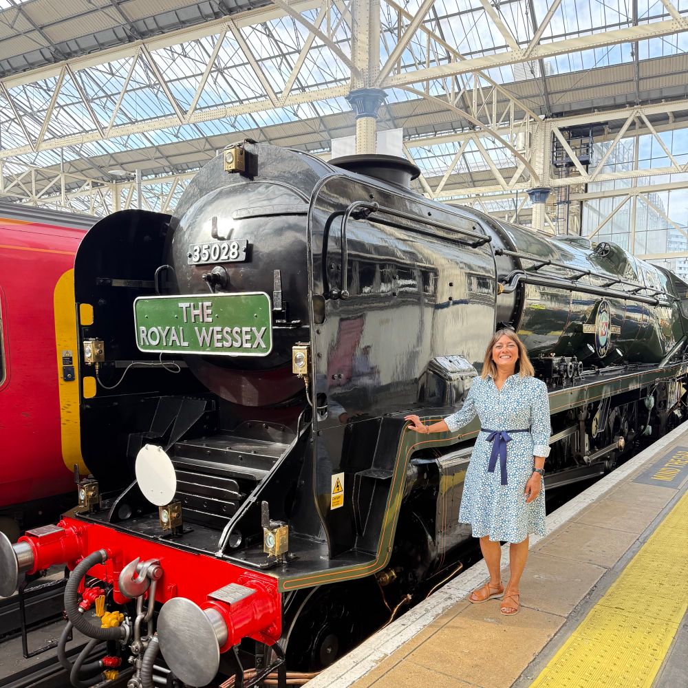 Woman standing next to locomotive train 