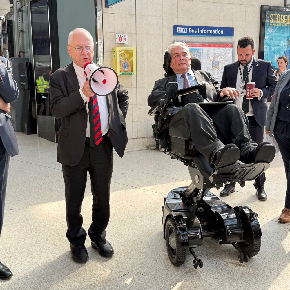 Three people on railway concourse