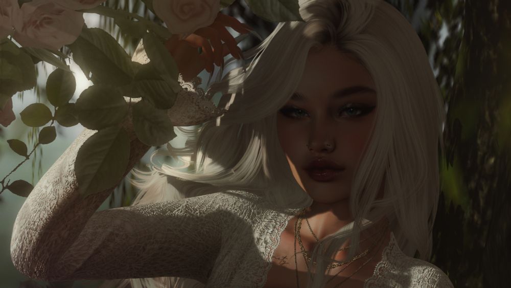 A woman stands beneath the shade of a tree, the suns warmth shining over her shoulder. She smiles adoringly at the camera, a look of hope shining brightly in her eyes. 