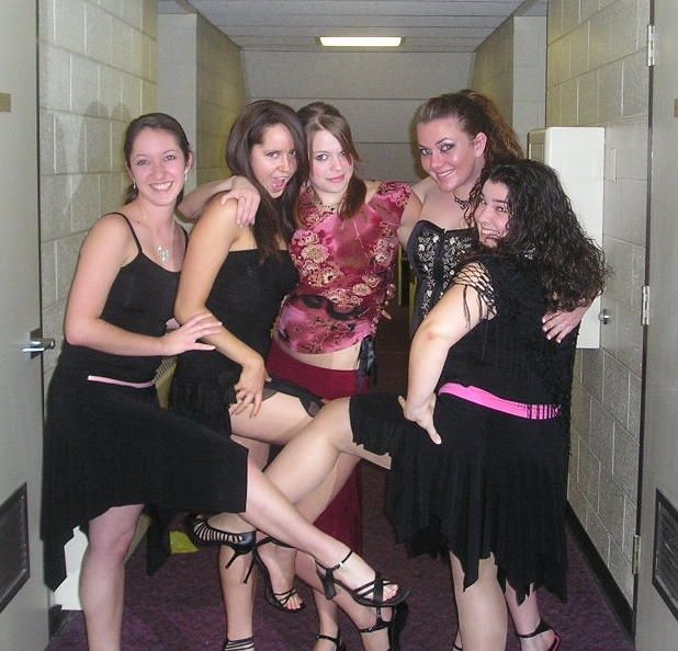 Cooper streaming and a group of friends in black and red outfits posing for the camera in a dorm hallway