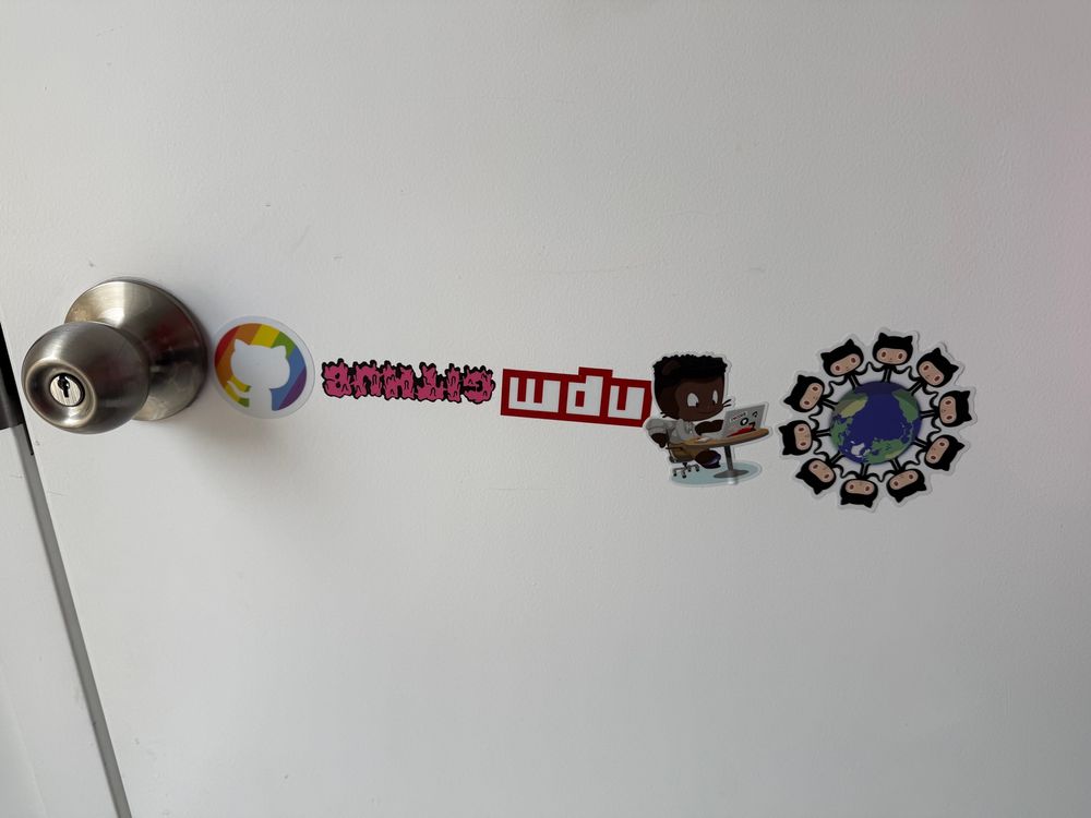 GitHub stickers on an interior door. Some upside down.