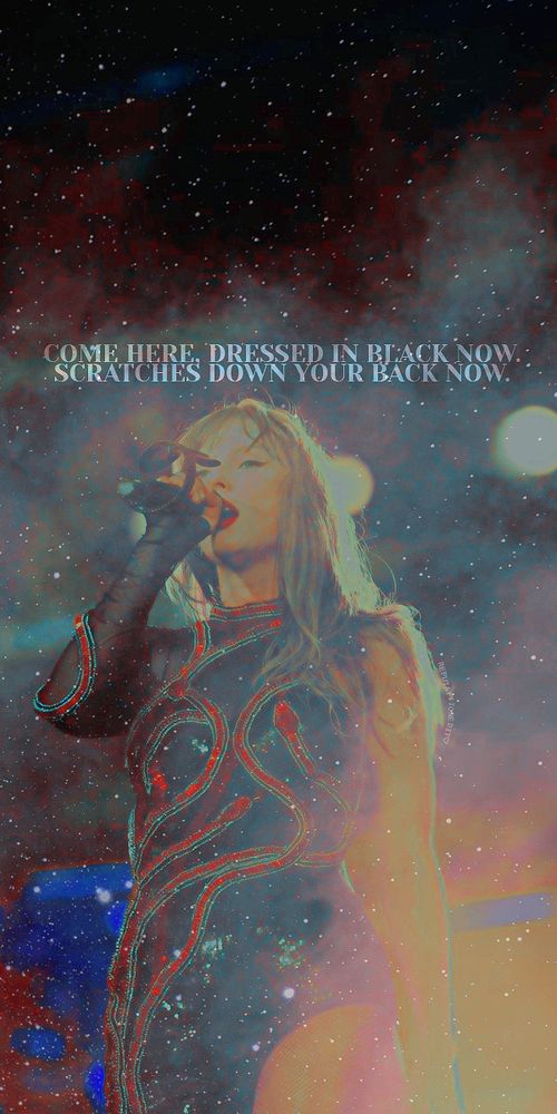 Taylor Swift preforming at The Eras Tour during the reputation set in the red snake bodysuit with So It Goes... lyrics wall
