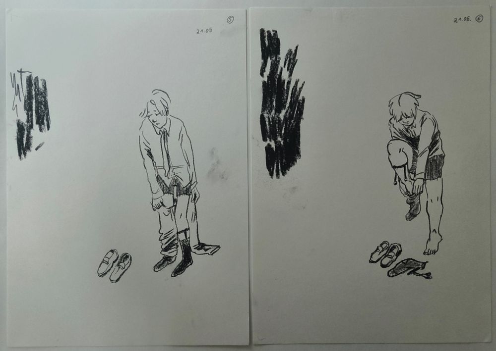 photo of two pages next to each other. both pages show the same character standing in white space, undressing. drawings in charcoal crayon.
the drawing on the left page shows the character taking off their trousers, on leg is still contained in the fabric tube of the trousers.
the drawing on the right page shows the character taking off their socks. one sock is already taken off and they are in process of taking off the second sock. they are wearing a vintage menswear style of sockholder with clips.
