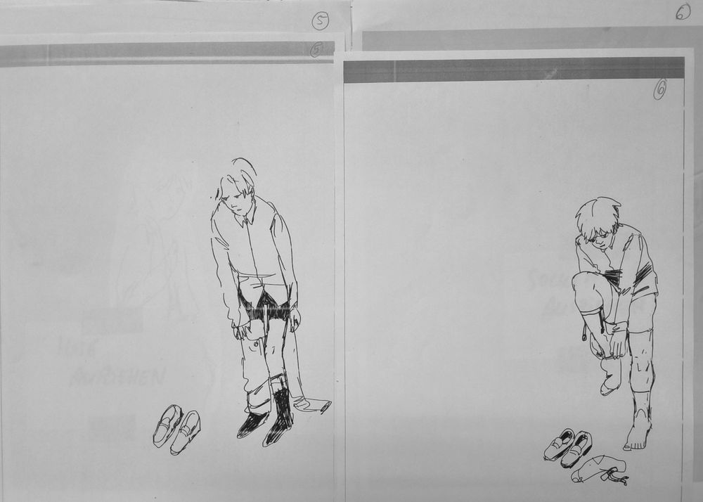 photo of two printed out pages next to each other. both pages show the same character standing in white space, undressing.
the drawing on the left page shows the character taking off their trousers, on leg is still contained in the fabric tube of the trousers.
the drawing on the right page shows the character taking off their socks. one sock is already taken off and they are in process of taking off the second sock. they are wearing a vintage menswear style of sockholder with clips.