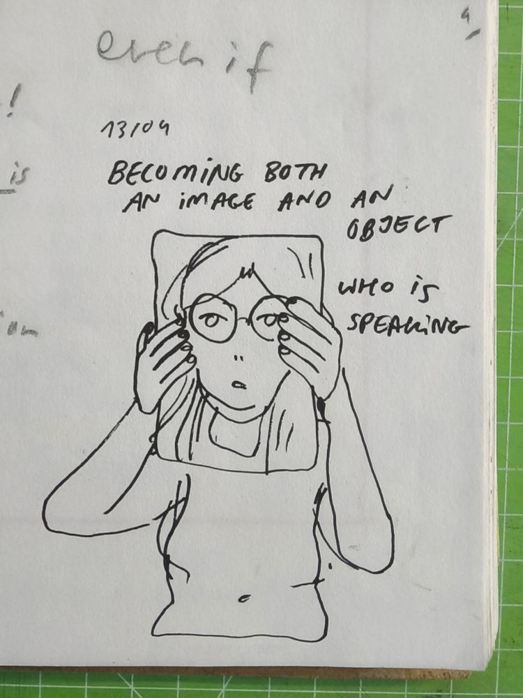 simple cartoon drawing of a person holding a sheet of paper in front of their face, on the sheet of paper is a drawing of a face with long hair and glasses. the drawing lines up so that it looks like the face is the persons face. 
text reads: 
"becoming both an image and an object
who is speaking"