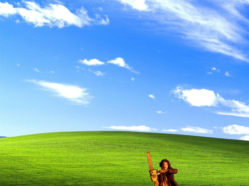 Leatherface dwarfed by Windows95 wallpaper