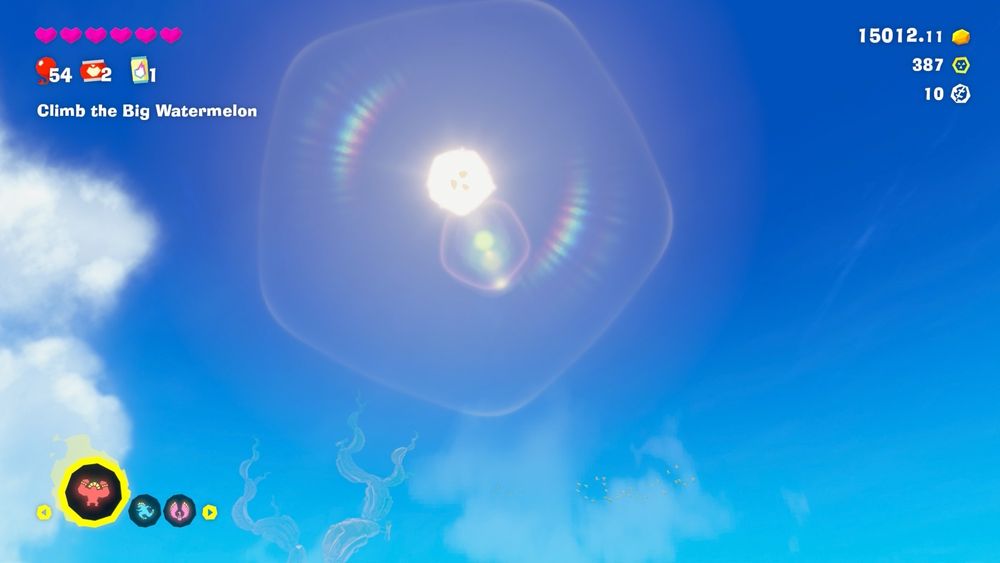 Blue sky with sun and lens flare. The sun itself is shaped like a banana slice. 