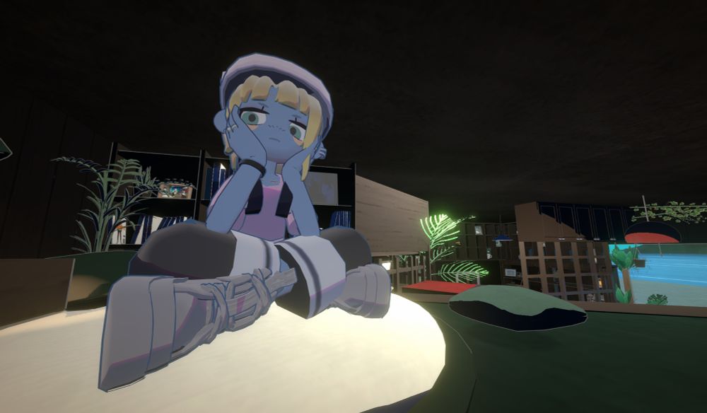 『gogh』のプレイ画面。ロフト上のクッションに胡坐で頬杖をつきながら座っているアバターの自分。