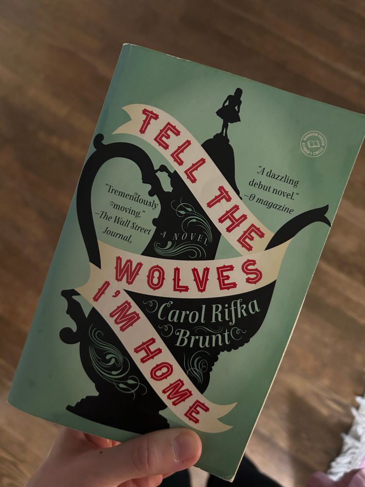 Paperback titled Tell the Wolves I’m home is light green with a black teapot on it. 