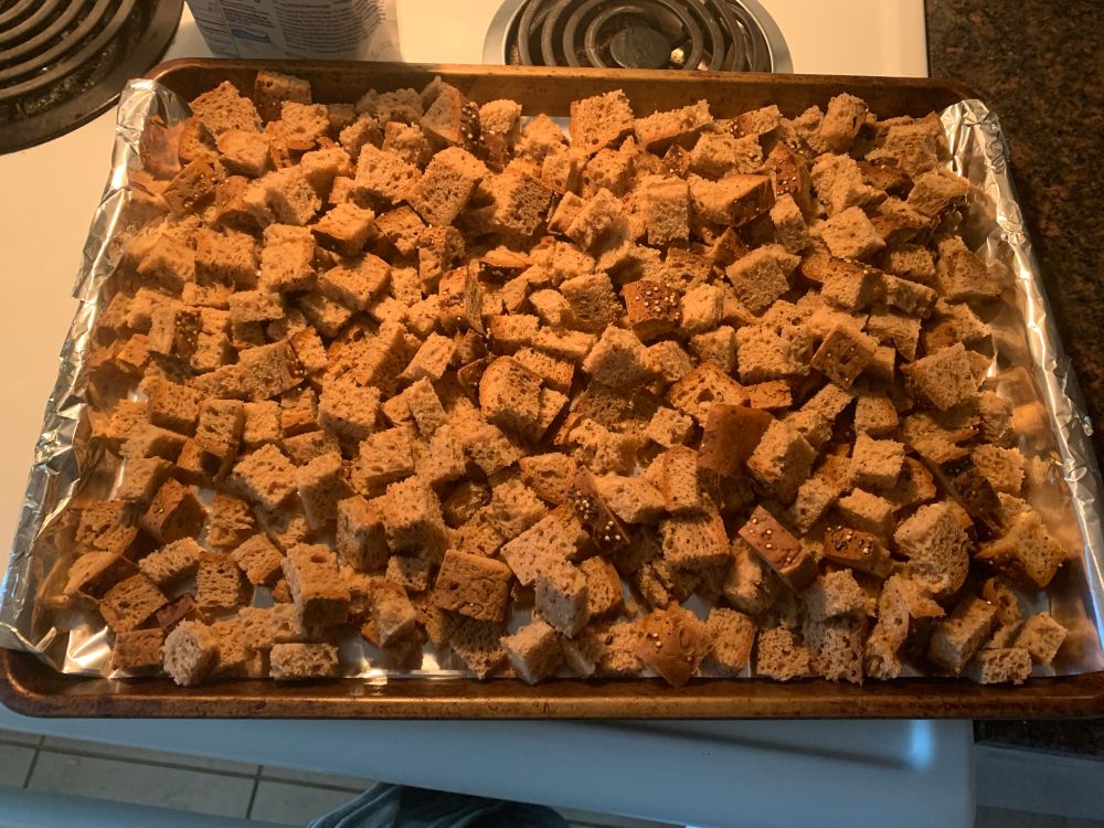 Pocture of a baking tray full of bread cubes.