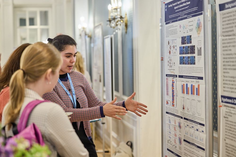 A scientist presenting her research poster at the 15th International Podocyte Conference