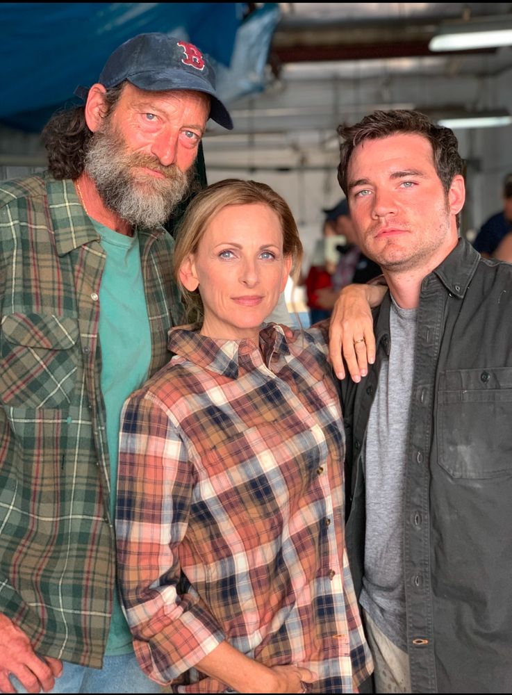 Actors Troy Kotsur and Marlee Matlin both in plaid tshirt stand along side Actor Daniel Durant dressed in a grey shirt as their characters in the film “CODA”