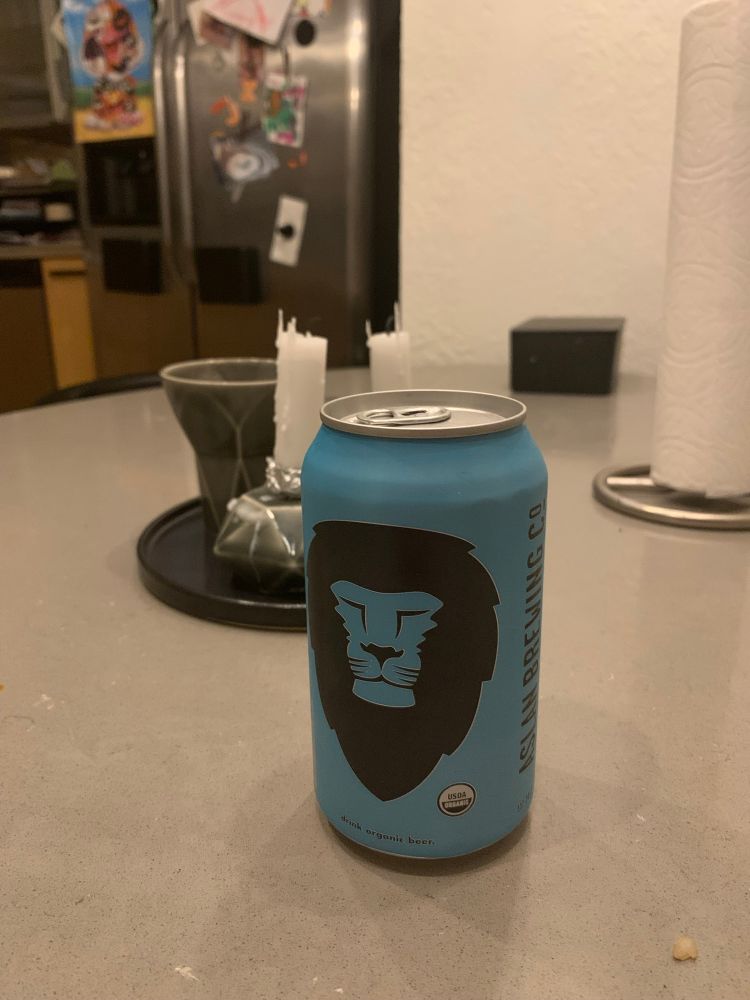 A can of Aslan Brewing’s Dawn Patrol ale in front of Shabbat candles and a kiddush cup. 