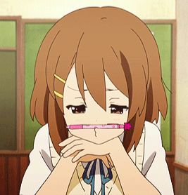 Screenshot of Yui of K-On!  She is holding a pen between her pouting upper lip and nose, eyebrows scrunched in thought.