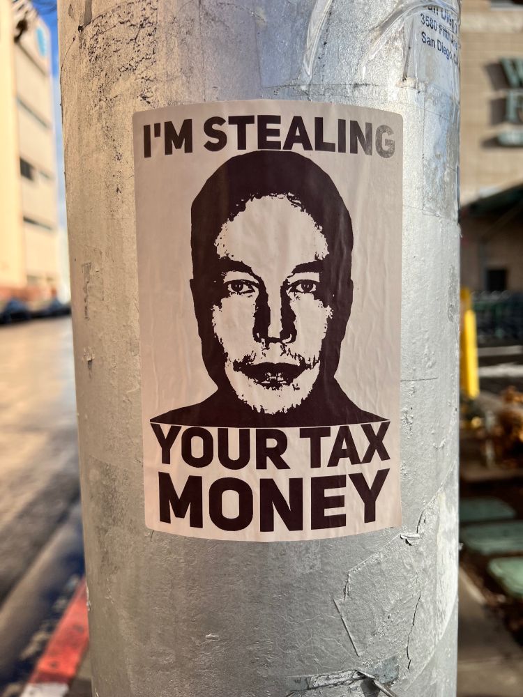 Mugshot of Elon Mudk that says “I’m stealing your tax money”