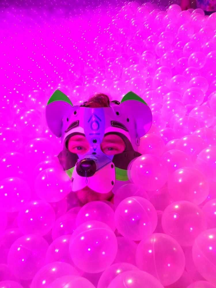 A pic of myself body deep in a swimming pool sized ball pit of clear plastic balls. 