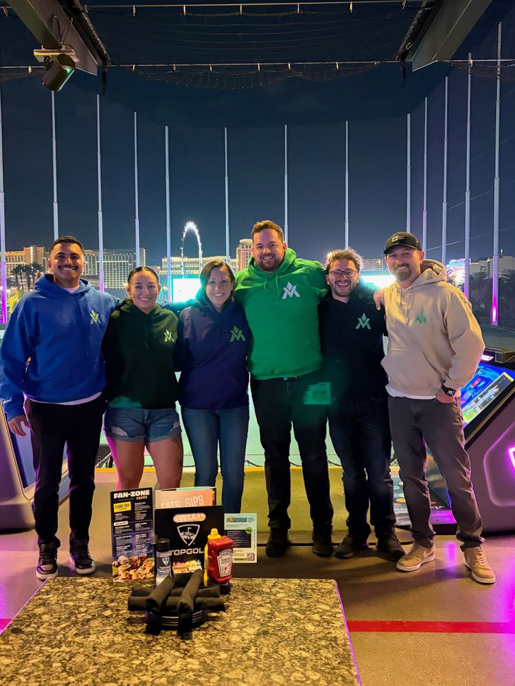 The A Team (Left to Right: Edward, Miko, Megan, Atlas, SENTI, Magik) in our "A" hoodies, in front of Top Golf & Vegas in the background.