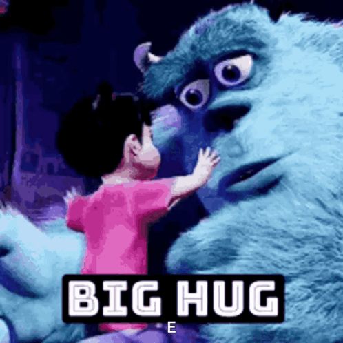 a little girl is hugging a monster from monsters inc