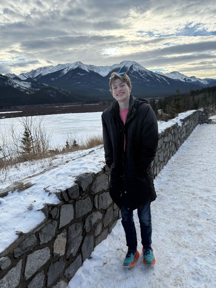 Me standing next to a frozen body of water 