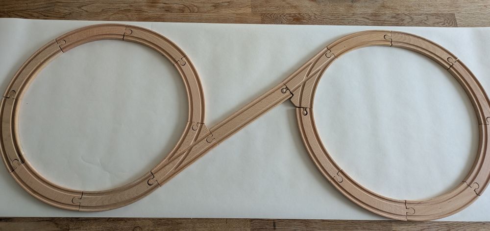 Brio train track arranged into a unsettling spiral