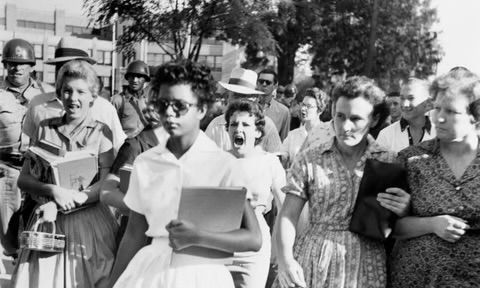 The picture is actually the Little Rock Nine and the open racism is from 1957.